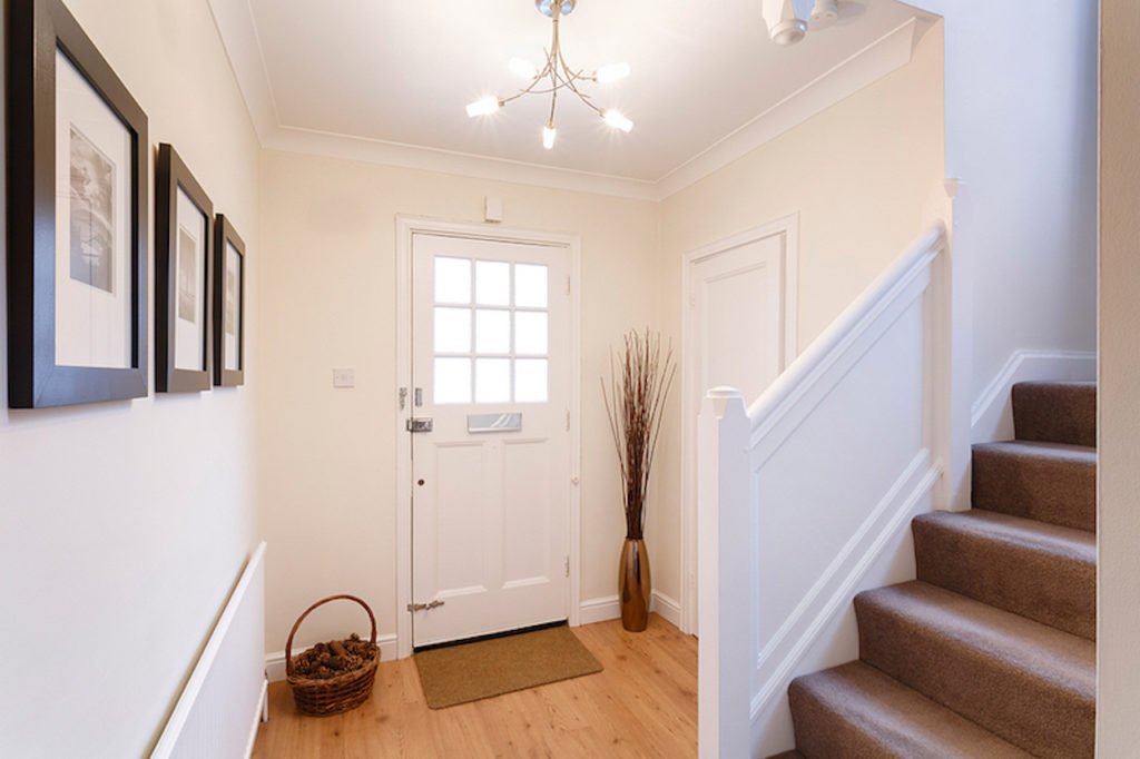 photo - Home interior showing hallway and carpeted stairs