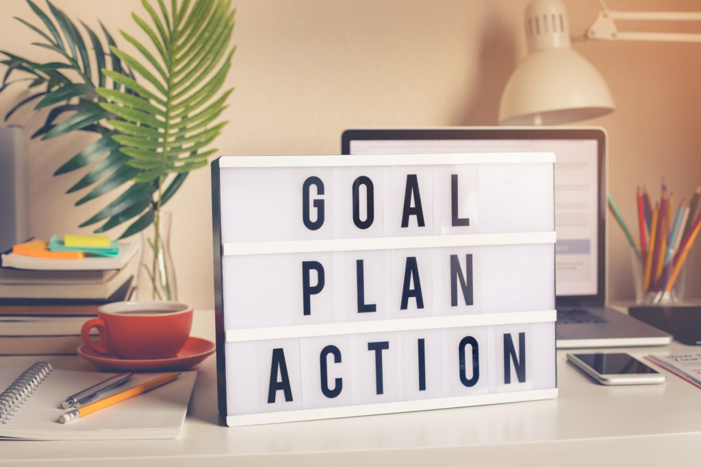 Goal,plan,action text on light box on desk table in home office Photo Goal Plan Action